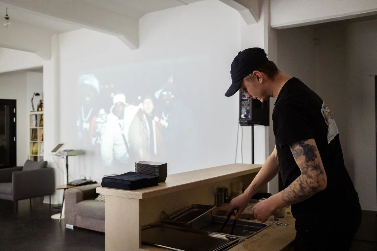 Jesper palvelee hodareja tapahtumassa projektorin valossa